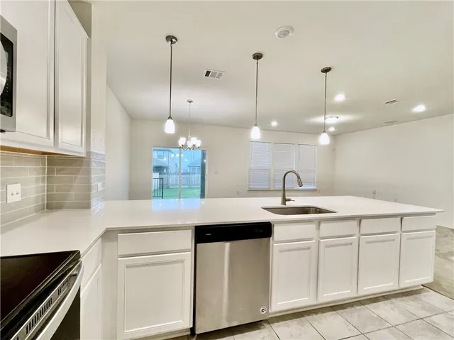 a kitchen with a sink and cabinets