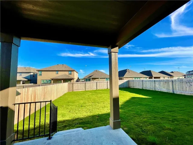 a view of an house with backyard space and balcony