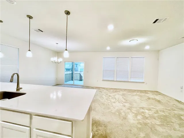 a kitchen with kitchen island a stove a sink and a counter top space
