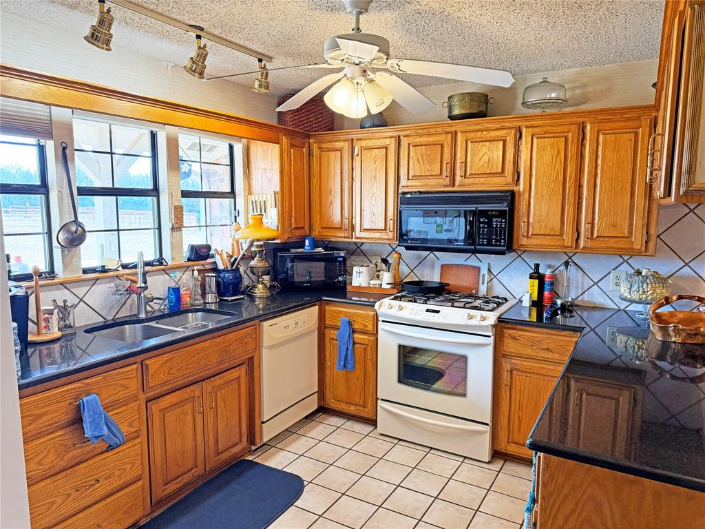 5393 Highway 5 Van Alstyne, TX 75495 - Photo 18 of 40 a kitchen with stainless steel appliances granite countertop a stove a sink and a refrigerator
