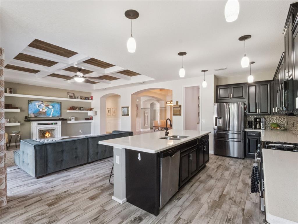 1025 Sadie Ridge Road Clermont, FL 34715 - Photo 11 of 50 a kitchen with stainless steel appliances granite countertop a sink and a refrigerator