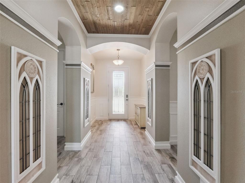 1025 Sadie Ridge Road Clermont, FL 34715 - Photo 2 of 50 a view of a hallway with wooden floor and a bathroom