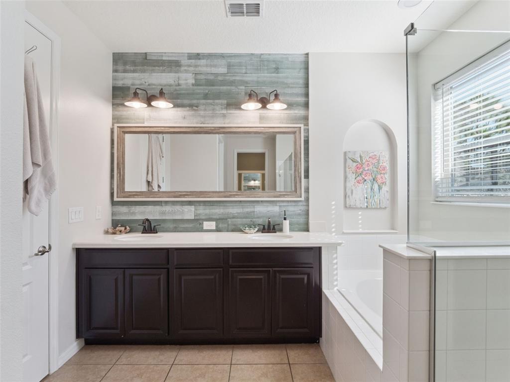 1025 Sadie Ridge Road Clermont, FL 34715 - Photo 26 of 50 a bathroom with a sink and a mirror