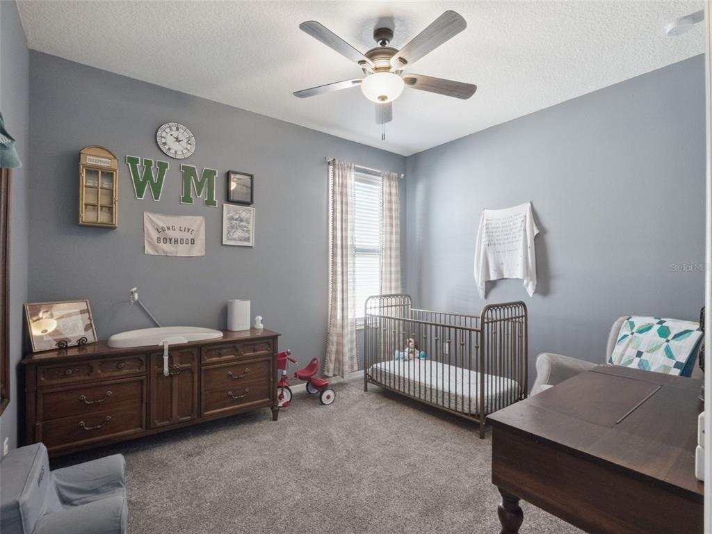 1025 Sadie Ridge Road Clermont, FL 34715 - Photo 29 of 50 a bedroom with a bed and a window