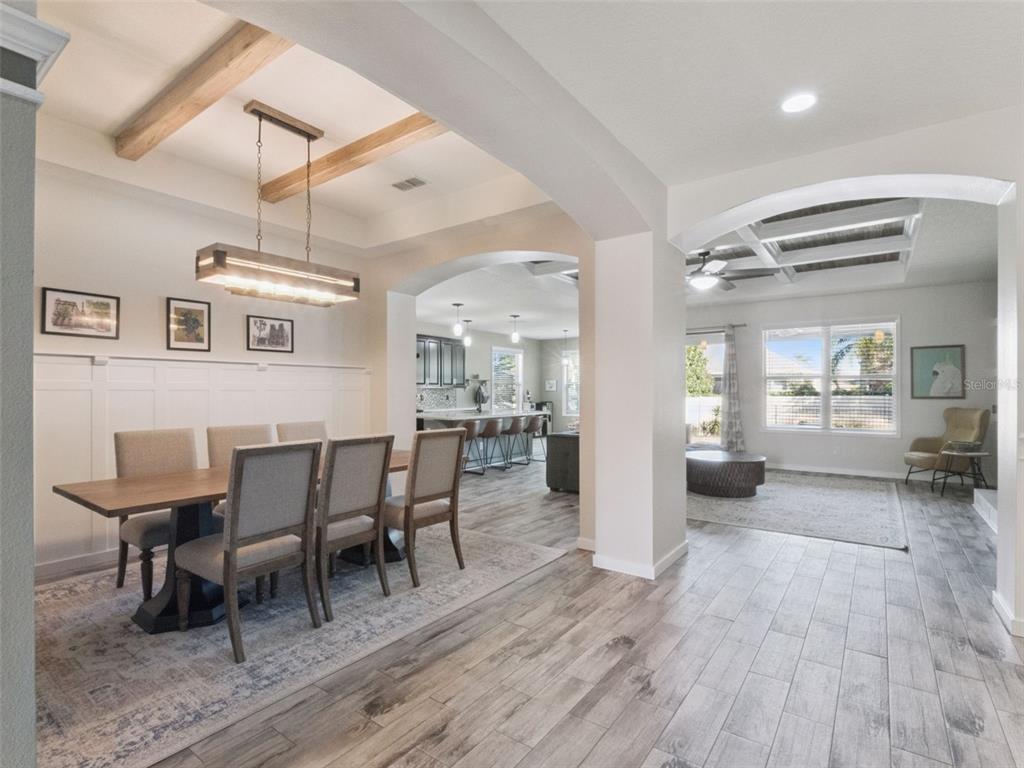1025 Sadie Ridge Road Clermont, FL 34715 - Photo 5 of 50 a view of a dining room with furniture and wooden floor