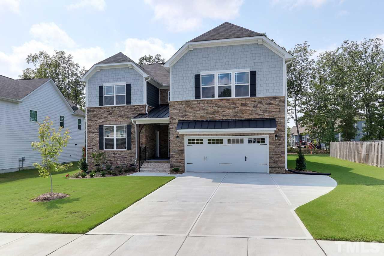 504 Cristobal Street, Unit 134 Rolesville, NC 27571 - Photo 2 of 30 a front view of a house with a yard and garage