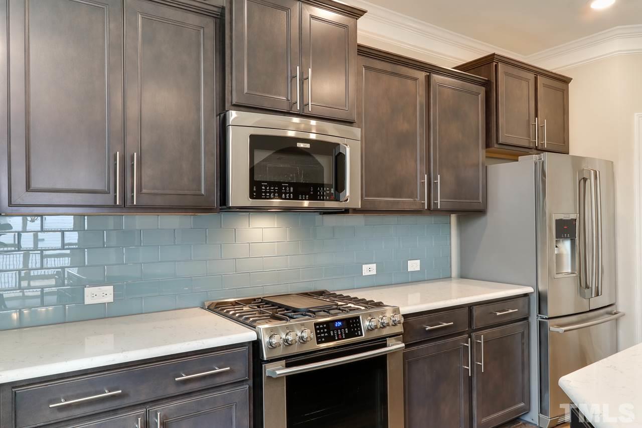 504 Cristobal Street, Unit 134 Rolesville, NC 27571 - Photo 11 of 30 a kitchen with stainless steel appliances a stove microwave and refrigerator