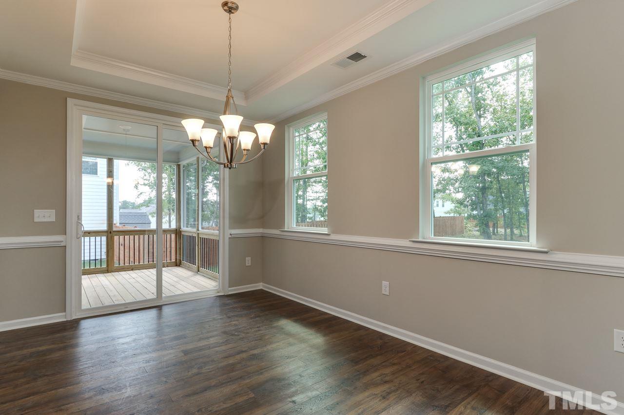 504 Cristobal Street, Unit 134 Rolesville, NC 27571 - Photo 12 of 30 a view of an empty room with wooden floor and a window