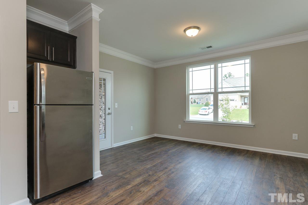 504 Cristobal Street, Unit 134 Rolesville, NC 27571 - Photo 15 of 30 a view of empty room with wooden floor and fan