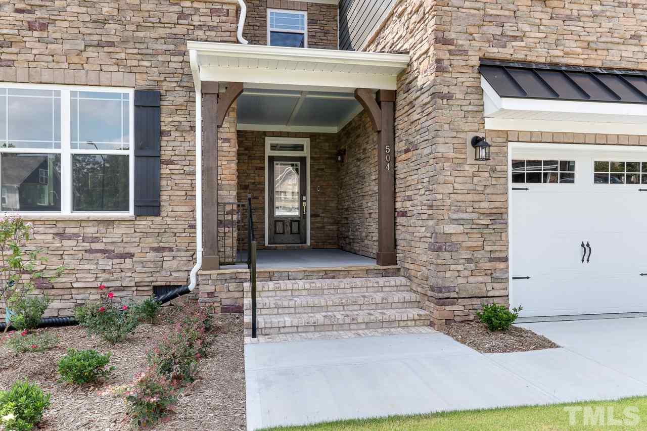 504 Cristobal Street, Unit 134 Rolesville, NC 27571 - Photo 3 of 30 a front view of a house with a yard and garage