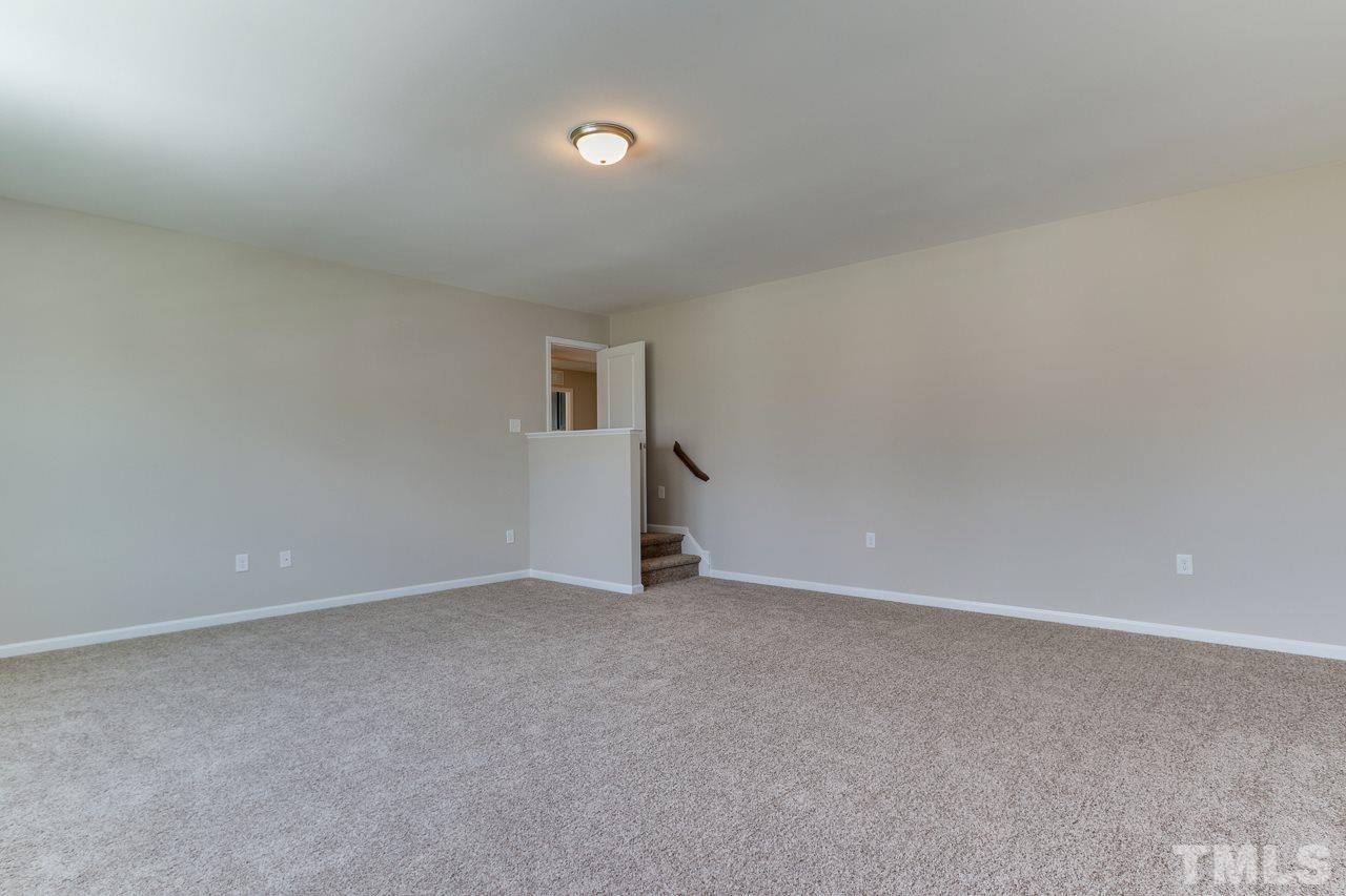 504 Cristobal Street, Unit 134 Rolesville, NC 27571 - Photo 24 of 30 a view of an empty room with wooden floor and a window