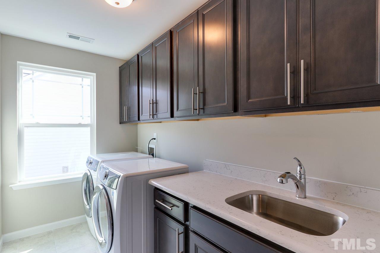 504 Cristobal Street, Unit 134 Rolesville, NC 27571 - Photo 28 of 30 a view of a sink and washer dryer