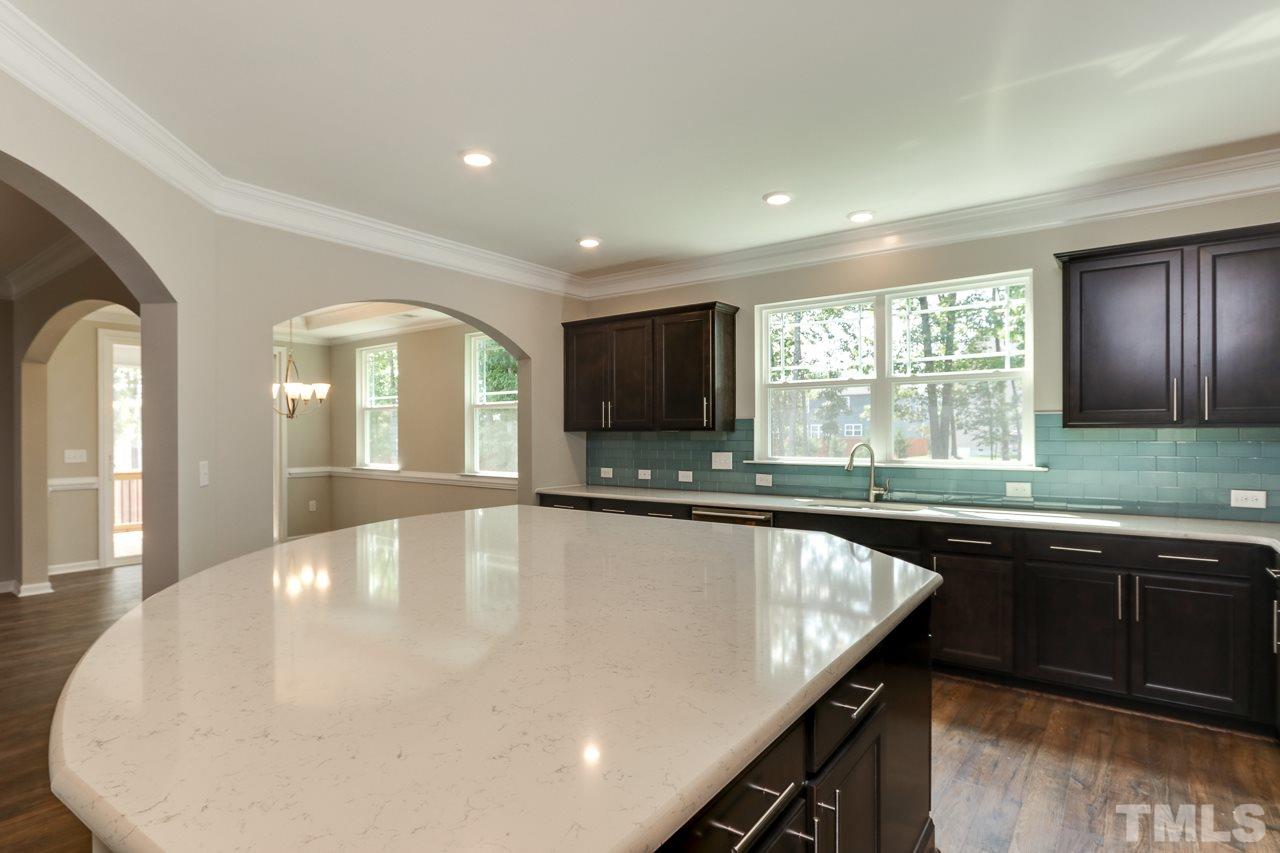 504 Cristobal Street, Unit 134 Rolesville, NC 27571 - Photo 9 of 30 a large kitchen with granite countertop a sink and cabinets
