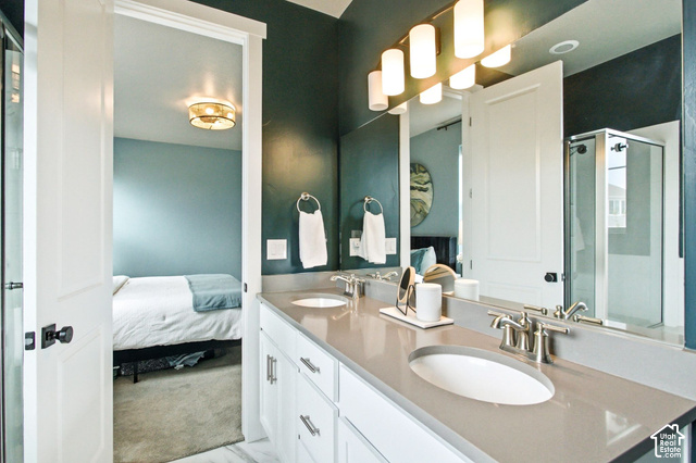 986 South Old Farm Road Heber City, UT 84032 - Photo 25 of 51 Dual vanity with undermount sinks, brushed nickel fixtures, a full-width mirror, and a glass-enclosed shower