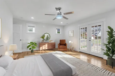 a bedroom with a bed and wooden floor