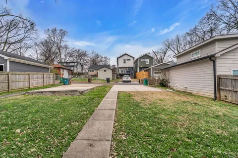 a front view of a house with a yard and trees