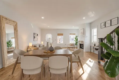 a dining room with furniture garden view and wooden floor