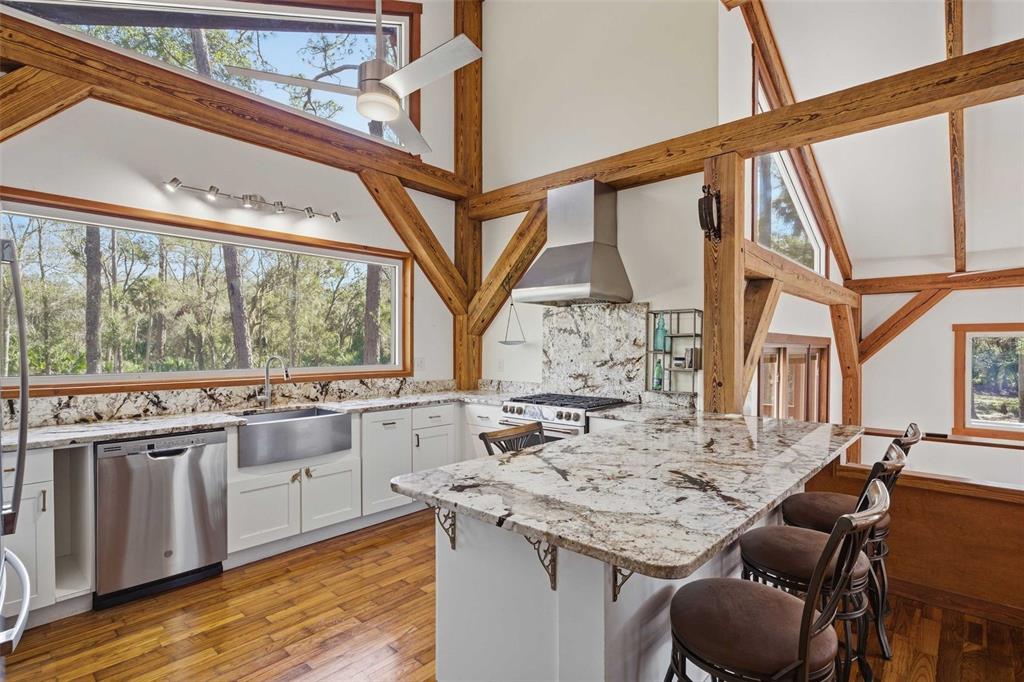 3490 Southeast 193rd Place Yankeetown, FL 34498 - Photo 13 of 71 a kitchen with stainless steel appliances granite countertop a stove and a dining table