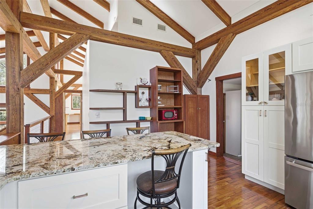 3490 Southeast 193rd Place Yankeetown, FL 34498 - Photo 16 of 71 a kitchen with stainless steel appliances kitchen island granite countertop a refrigerator and a stove top oven