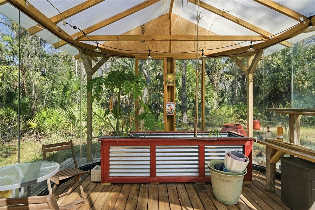 3490 Southeast 193rd Place Yankeetown, FL 34498 - Photo 33 of 71 a backyard of a house with wooden floor a yard and outdoor seating