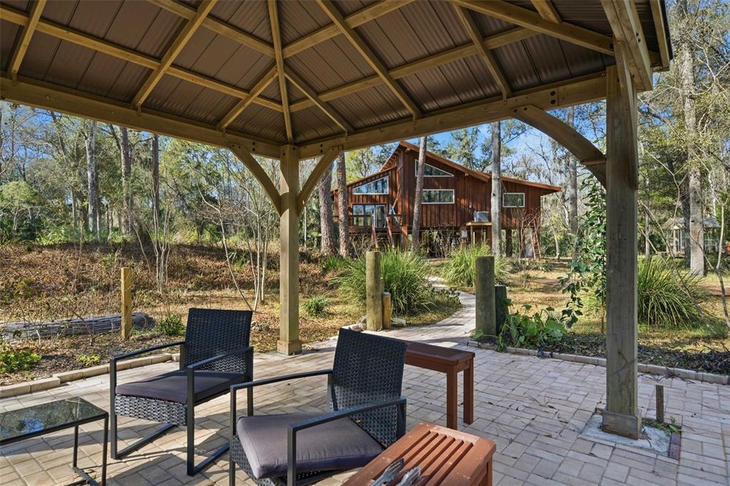 3490 Southeast 193rd Place Yankeetown, FL 34498 - Photo 37 of 71 a patio with table and chairs and potted plants