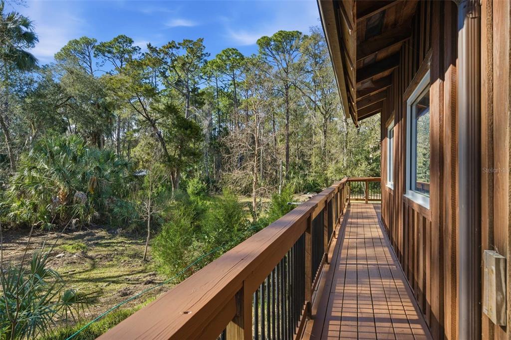 3490 Southeast 193rd Place Yankeetown, FL 34498 - Photo 5 of 71 a view of balcony with wooden floor and fence