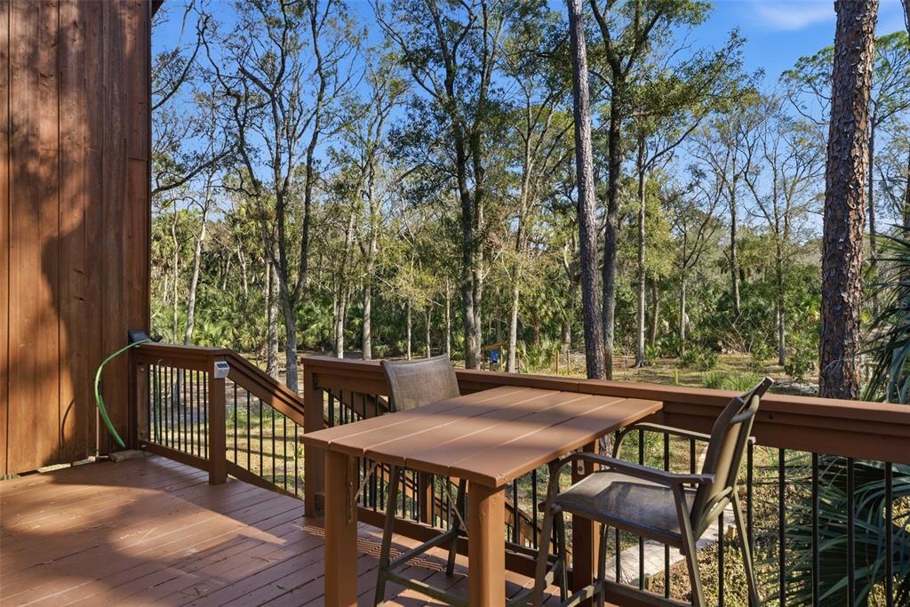 3490 Southeast 193rd Place Yankeetown, FL 34498 - Photo 6 of 71 a view of a patio with table and chairs and wooden floor