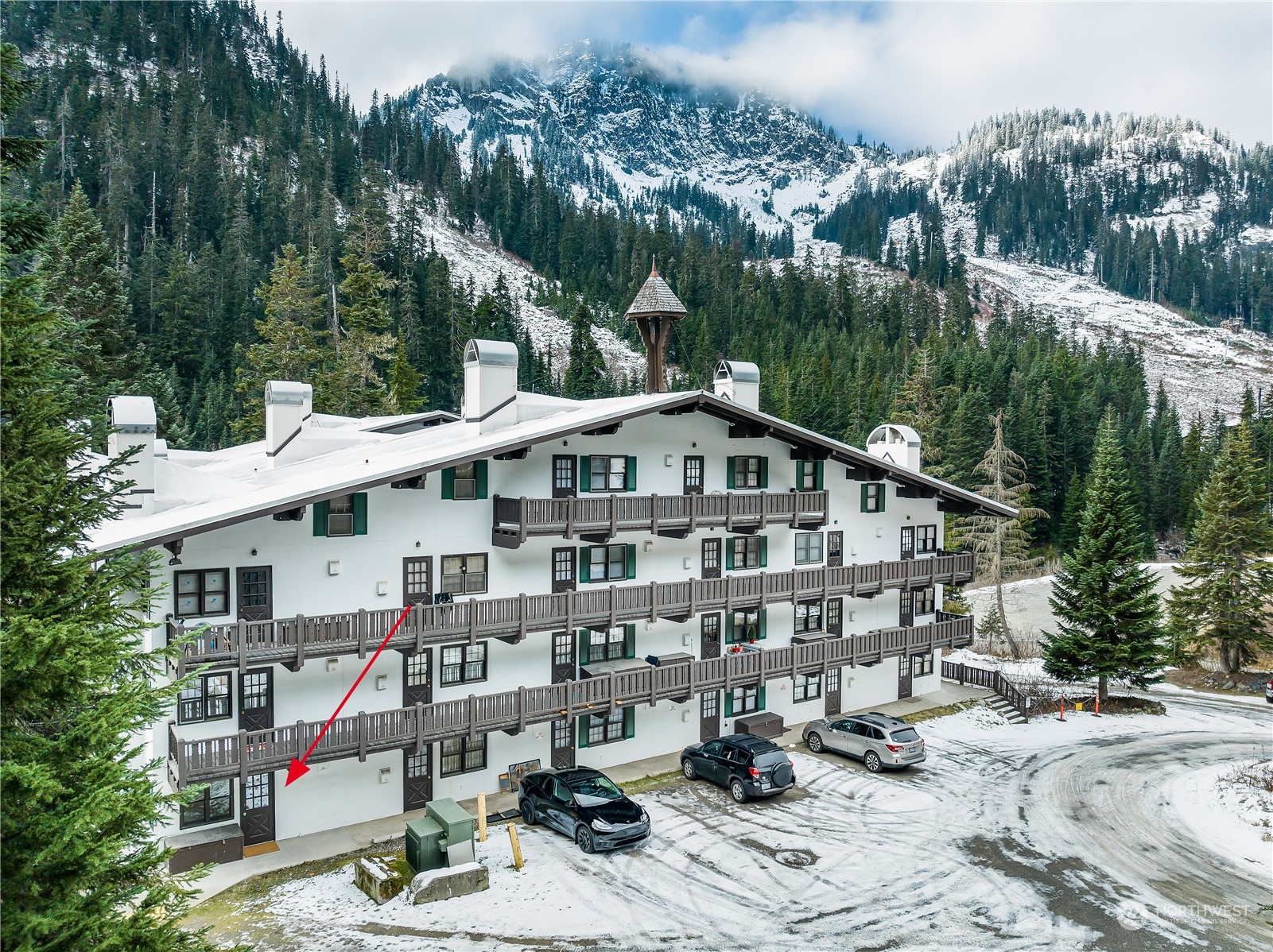17800 Alpental Access Road, Unit 1114 Snoqualmie Pass, WA 98068 - Photo 4 of 21 a view of a large white building with a bench in front of house
