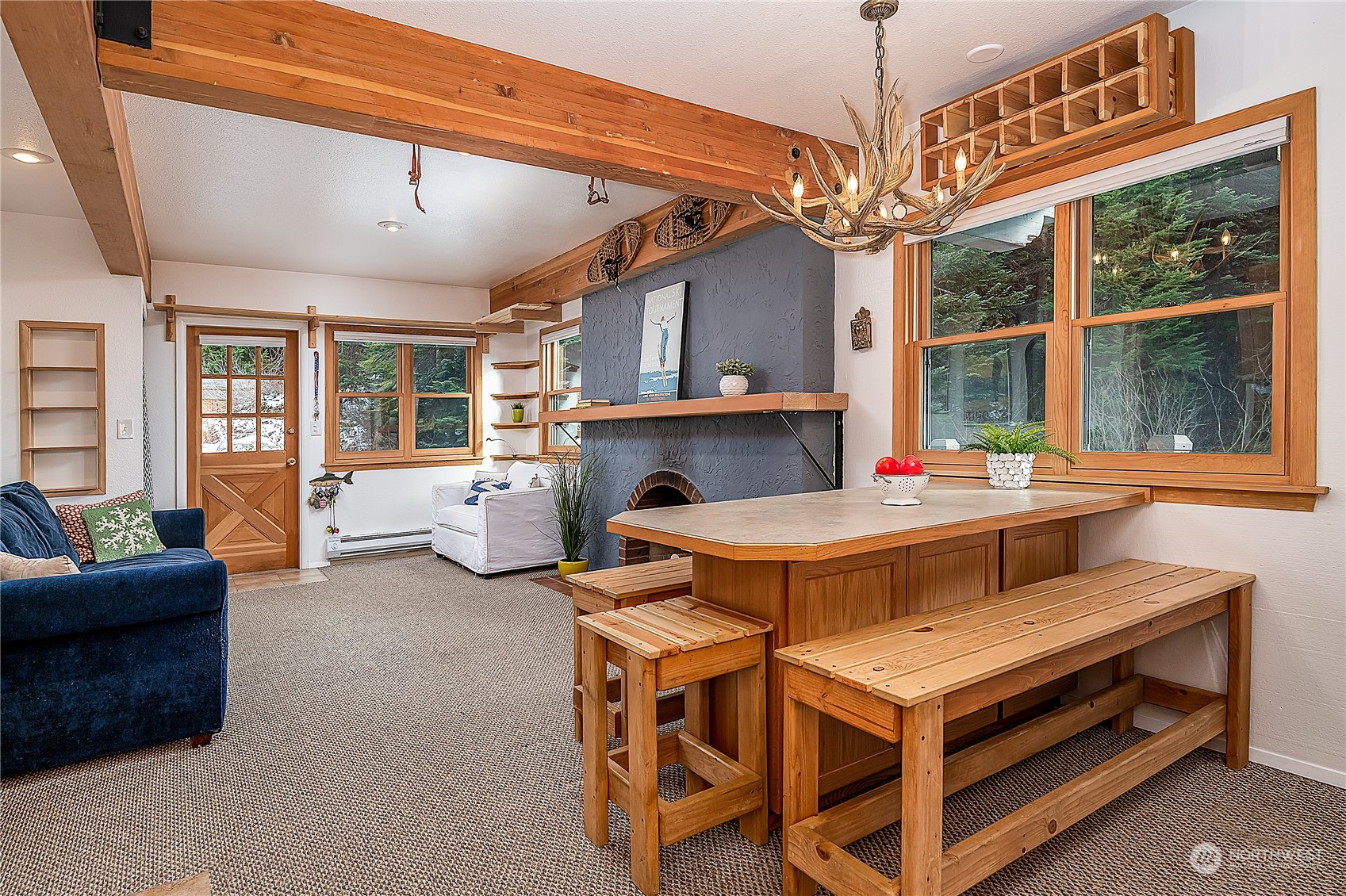 17800 Alpental Access Road, Unit 1114 Snoqualmie Pass, WA 98068 - Photo 8 of 21 a living room with furniture a fireplace and a chandelier