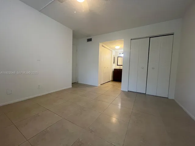 a view of an empty room with a bathroom