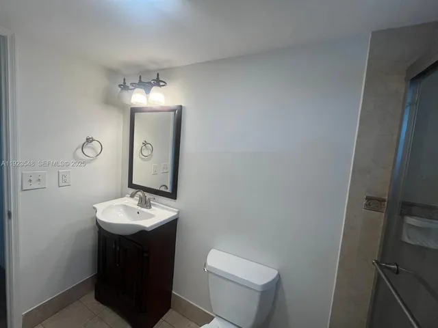 a bathroom with a sink a toilet and mirror