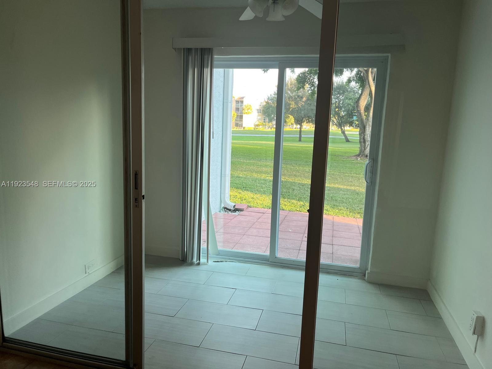 9421 Evergreen Place, Unit 107 Davie, FL 33324 - Photo 22 of 49 a bathroom with a glass door
