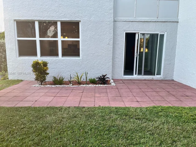 a vase of flowers sitting on a floor