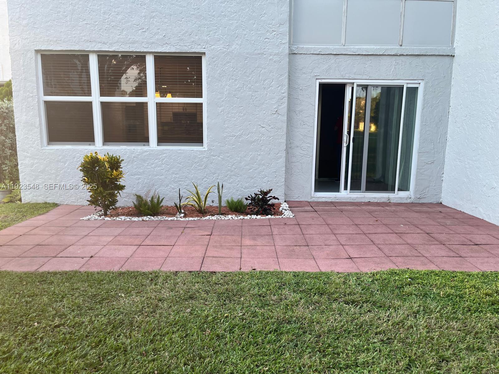 9421 Evergreen Place, Unit 107 Davie, FL 33324 - Photo 27 of 49 a front view of a house with a yard