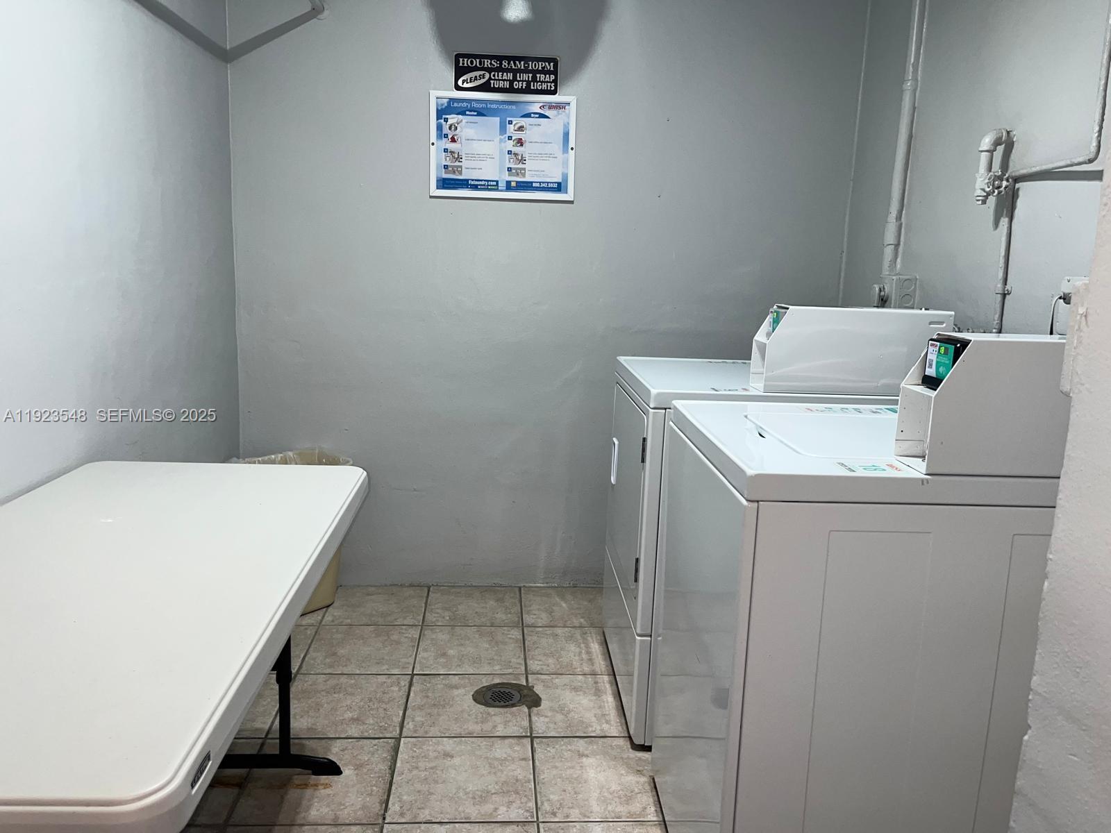 9421 Evergreen Place, Unit 107 Davie, FL 33324 - Photo 29 of 49 a utility room with dryer and washer