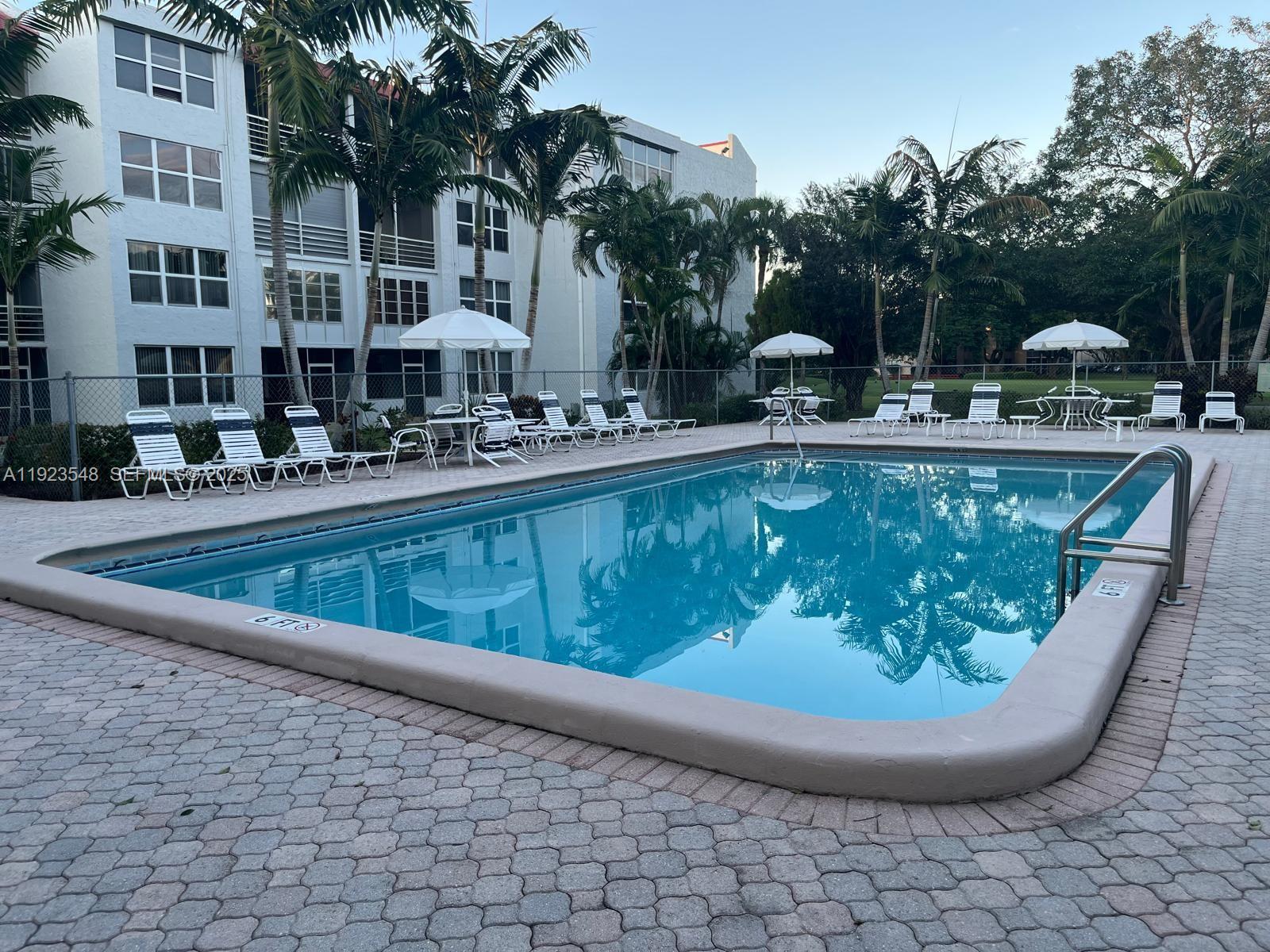 9421 Evergreen Place, Unit 107 Davie, FL 33324 - Photo 33 of 49 a view of a swimming pool with a sitting space