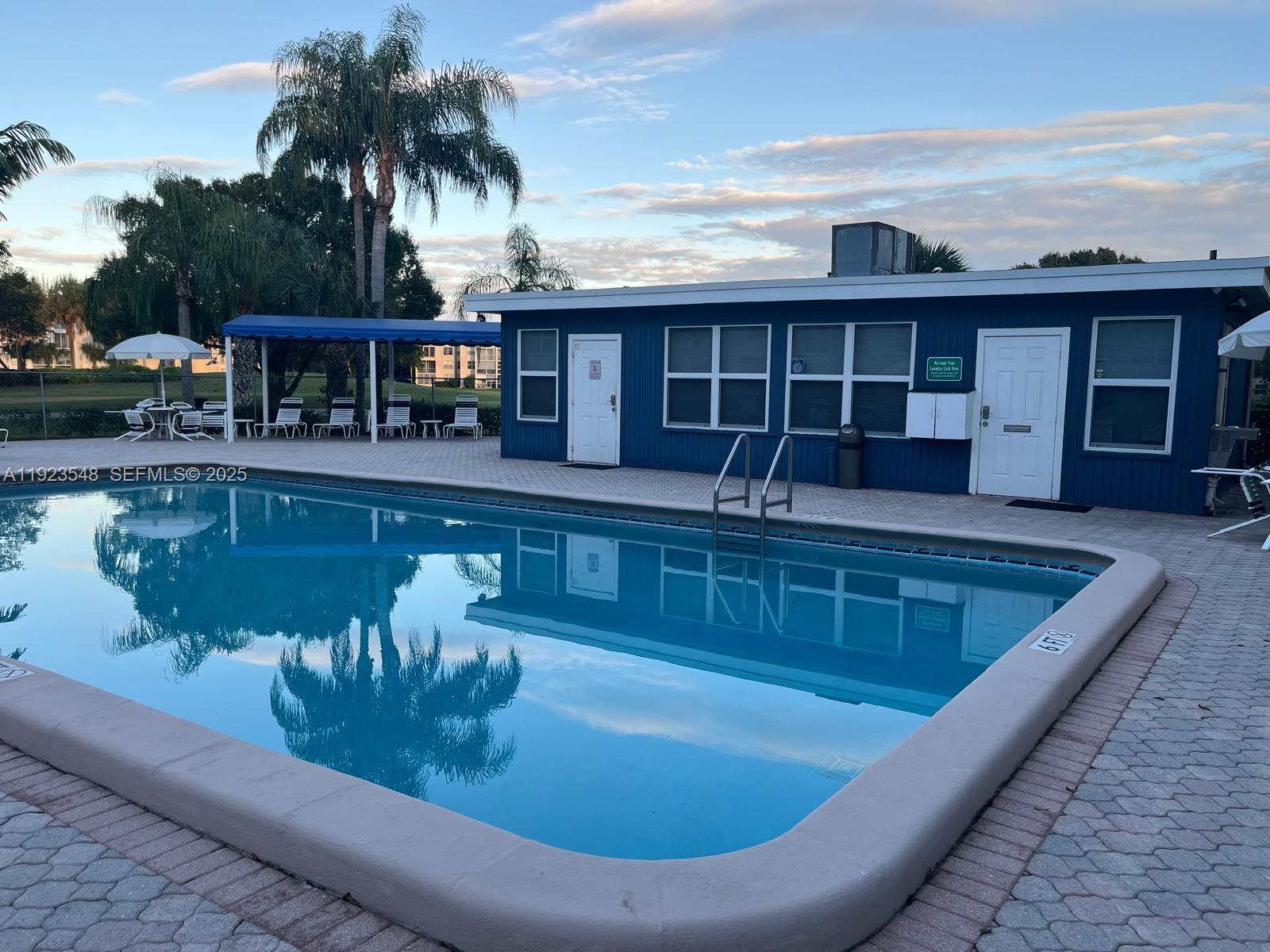 9421 Evergreen Place, Unit 107 Davie, FL 33324 - Photo 34 of 49 a view of a house with swimming pool and sitting area