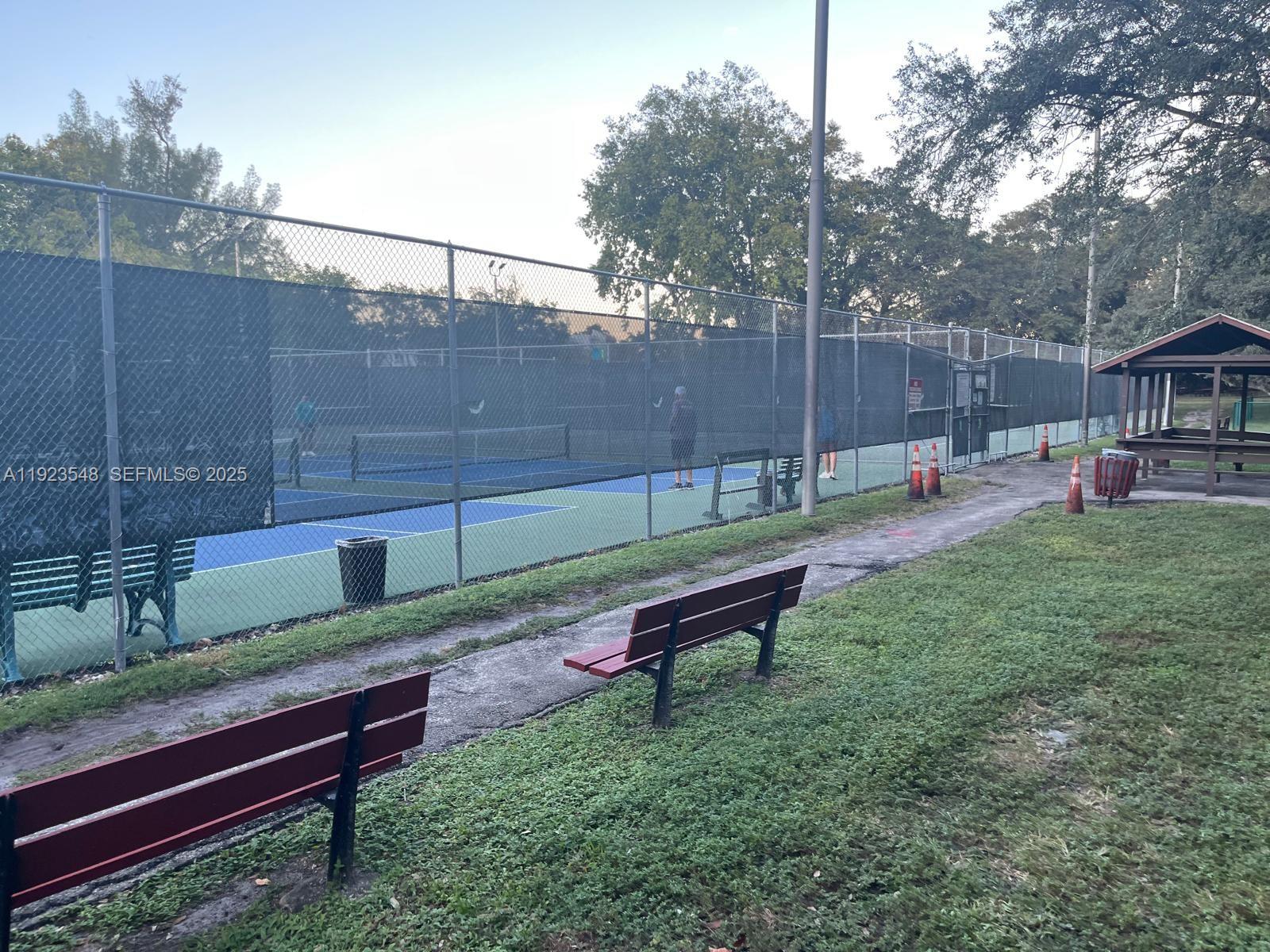 9421 Evergreen Place, Unit 107 Davie, FL 33324 - Photo 39 of 49 a view of a bench in a yard