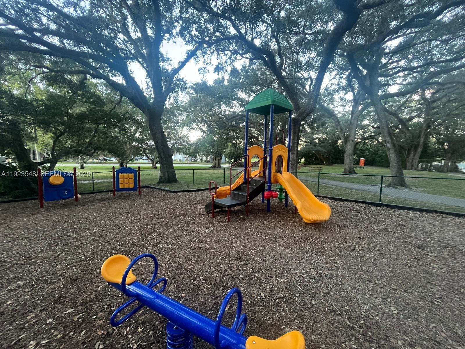 9421 Evergreen Place, Unit 107 Davie, FL 33324 - Photo 41 of 49 a childrens park with lots of swings and slides