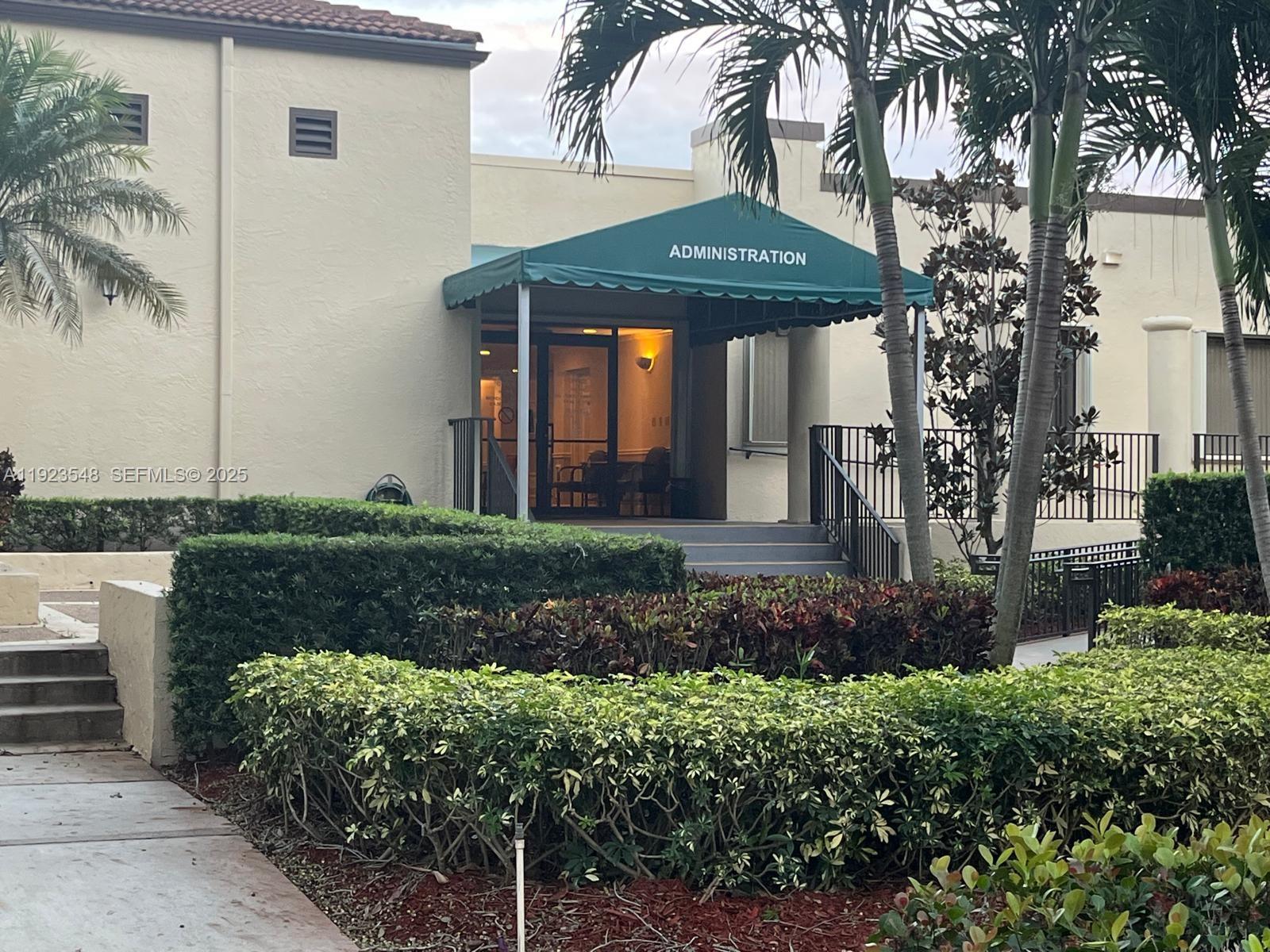 9421 Evergreen Place, Unit 107 Davie, FL 33324 - Photo 42 of 49 a front view of a house with garden