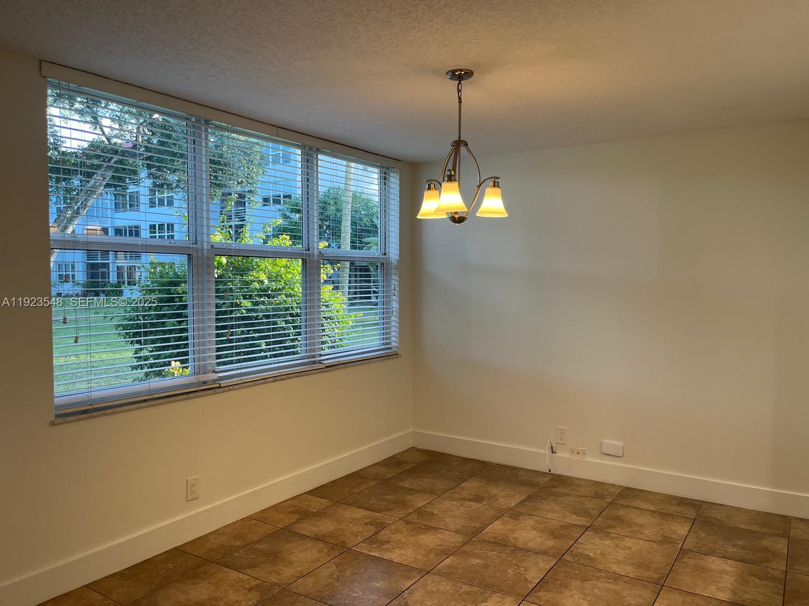 9421 Evergreen Place, Unit 107 Davie, FL 33324 - Photo 7 of 49 a view of empty room with window