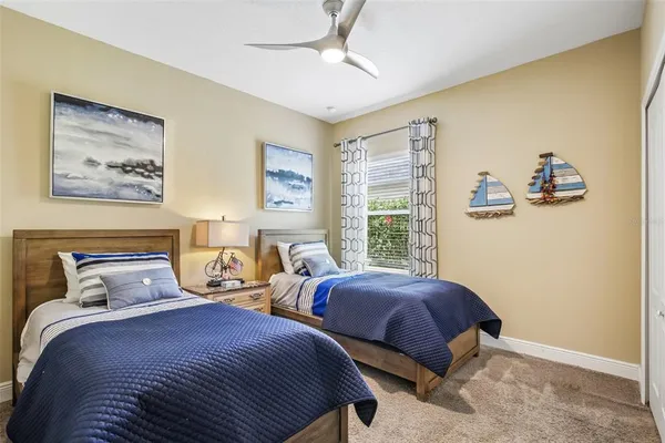 a bedroom with two beds and a large window
