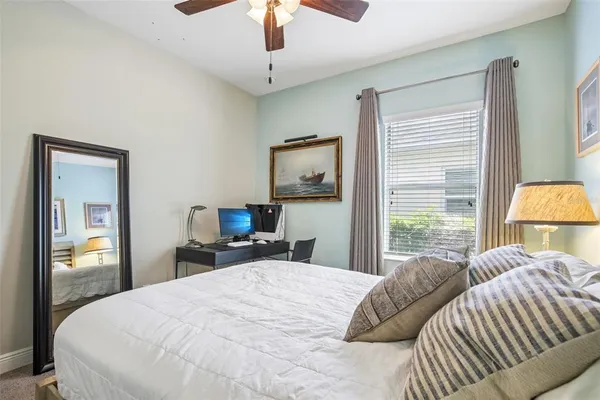 a bedroom with a bed and window with lamp