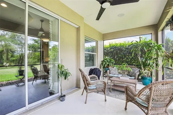 a patio with yard glass top table and chairs