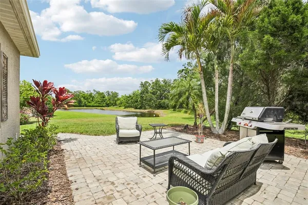 a view of a patio with couches and a table and chairs with garden view