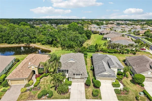 an aerial view of a house with garden space and lake view