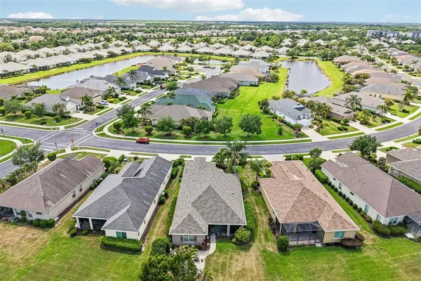 an aerial view of residential houses with outdoor space