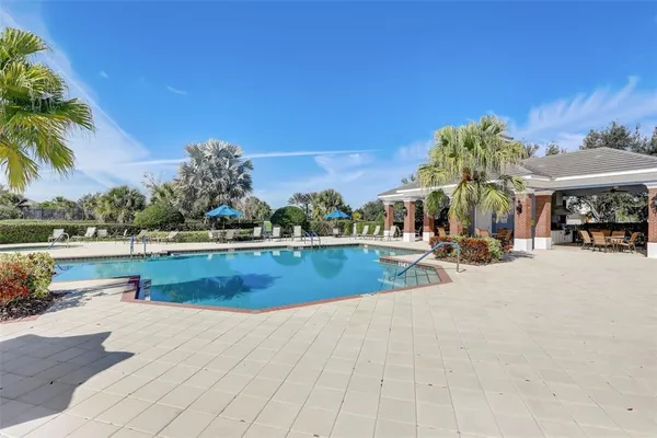 a view of a swimming pool and lounge chairs