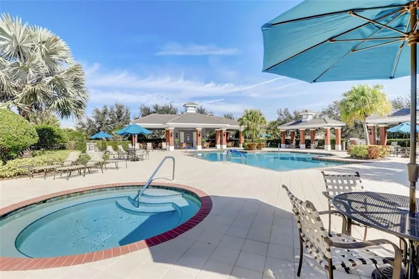 a swimming pool with outdoor seating yard and barbeque oven