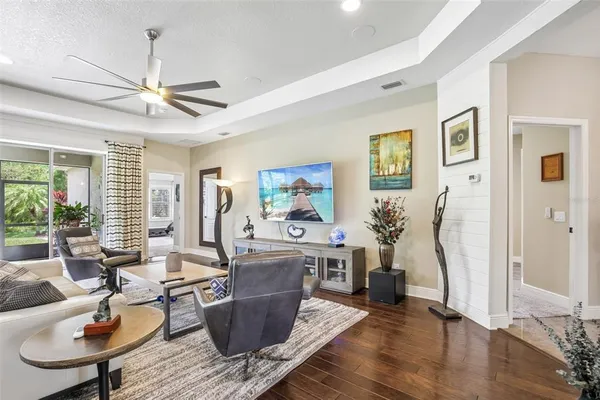 a living room with furniture a window and a chandelier